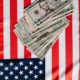 american dollars placed on national flag
