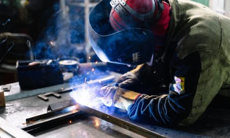 man welding metal bars